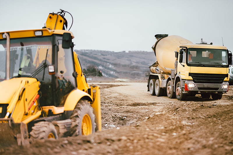 Excavator and truck with commercial motor insurance policy